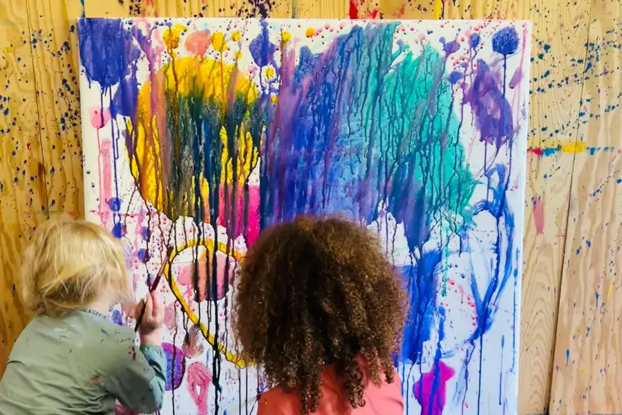 Children painting together in the art studio